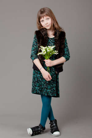 young happy girl.  little girl on a gray backgroundの写真素材