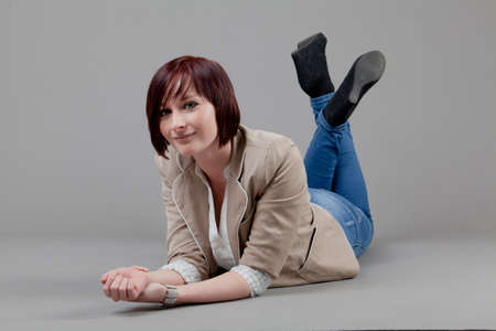 attractive smiling woman. Portrait of an attractive young woman.  lady posing on grey background.の写真素材