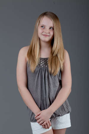 young happy girl.  little girl on a gray backgroundの写真素材