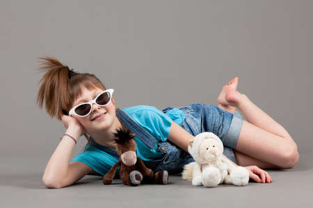 young happy girl   little girl on a gray backgroundの写真素材
