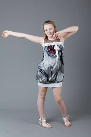 young happy girl   little girl on a gray backgroundの写真素材