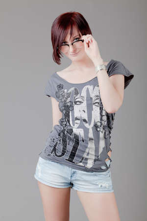attractive smiling woman  Portrait of an attractive young woman   lady posing on grey background の写真素材