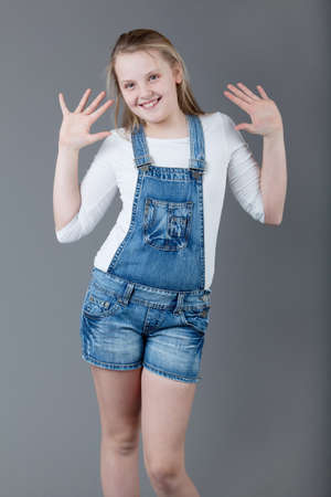 young happy girl   little girl on a gray backgroundの写真素材