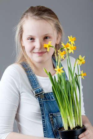 young happy girl   little girl on a gray backgroundの写真素材