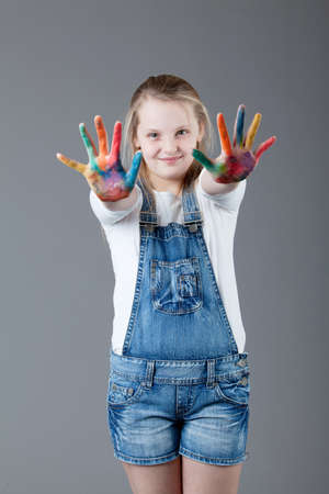 young happy girl   little girl on a gray backgroundの写真素材