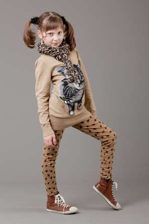 young happy girl   little girl on a gray backgroundの写真素材