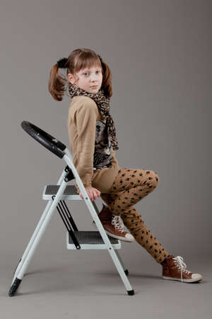 young happy girl   little girl on a gray backgroundの写真素材