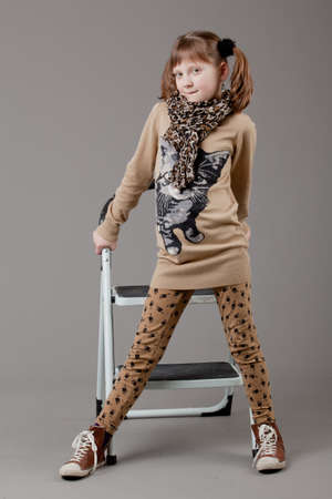 young happy girl   little girl on a gray backgroundの写真素材