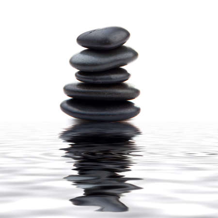Black massage stones stacked, isolated.の写真素材