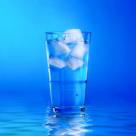 Glass of fresh water with cubes of iceの写真素材