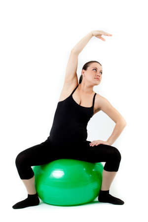 Pregnant woman excercises with gymnastic ball.の写真素材