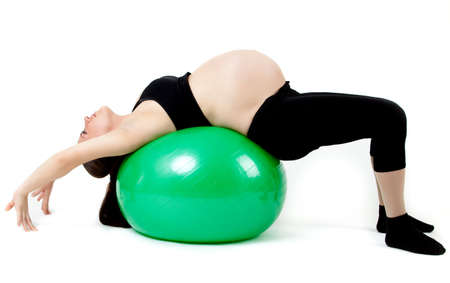 Pregnant woman excercises with gymnastic ball.の写真素材