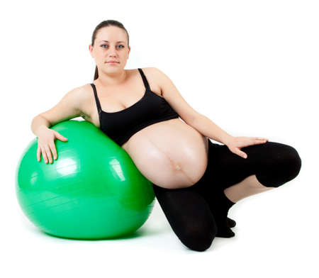 Pregnant woman excercises with gymnastic ball.の写真素材