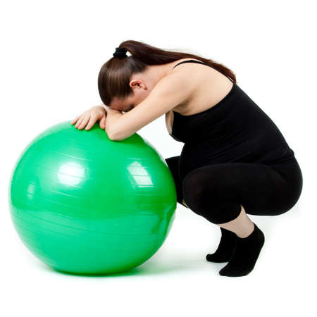 Pregnant woman excercises with gymnastic ball.の写真素材
