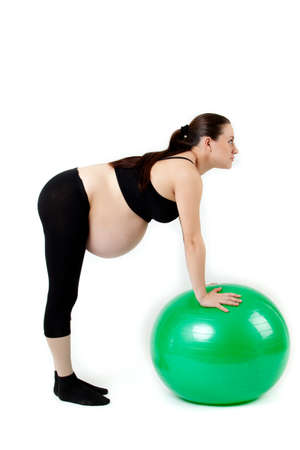 Pregnant woman excercises with gymnastic ball.の写真素材