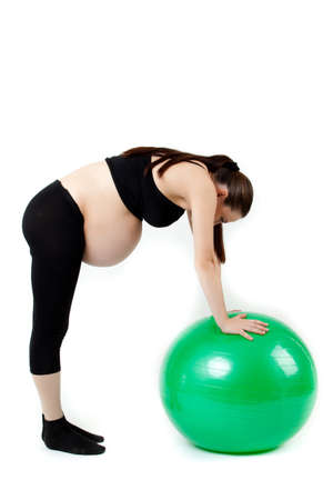 Pregnant woman excercises with gymnastic ball.の写真素材