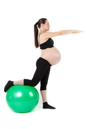 Beautiful pregnant woman sitting with exercise bal  Isolated on white backgroundの写真素材