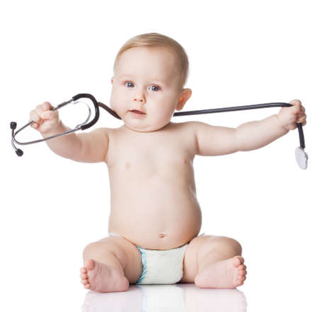 Sweet baby with stethoscope on a white background  Adorable baby boy on whiteの写真素材