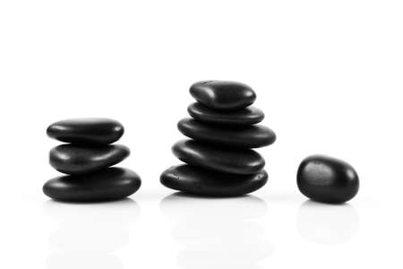 Black massage stones stacked, isolated.の写真素材