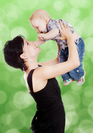 Beautiful happy mother with attractive baby boyの写真素材