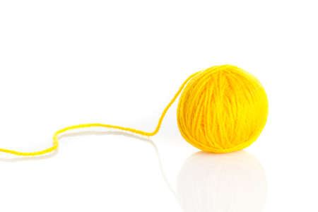Yellow wool yarn ball isolated on white backgroundの写真素材