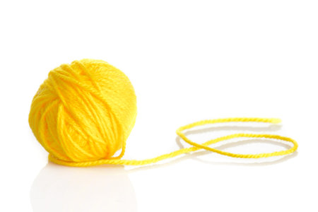Yellow wool yarn ball isolated on white background
