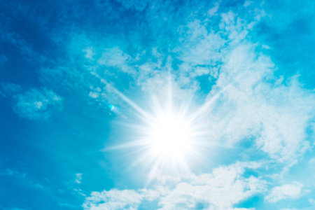 Blue sky with clouds and sunの写真素材