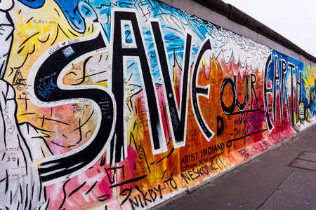 BERLIN, GERMANY - MARCH 20: Berlin Wall graffiti seen on March 22, 2015, Berlin, East Side Gallery. It's a 1.3 km long part of original Berlin Wall which collapsed in 1989.のeditorial素材
