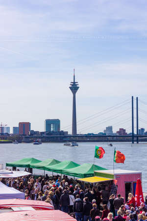 DUSSELDORF, GERMANY - APRIL 12, 2015: People are enjoying the traditional Dusseldorf  Fish Market. Fish Market By the harbor in Dusseldorf, Germanyのeditorial素材