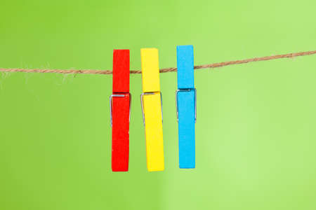 wooden clothespin hanging on rope.  colorful clothespins.の写真素材