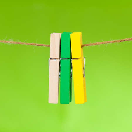 wooden clothespin hanging on rope.  colorful clothespins.の写真素材