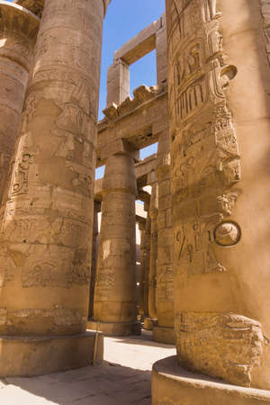 massive columns. Luxor, Egypt. old egypt hieroglyphs carved on the stoneの写真素材