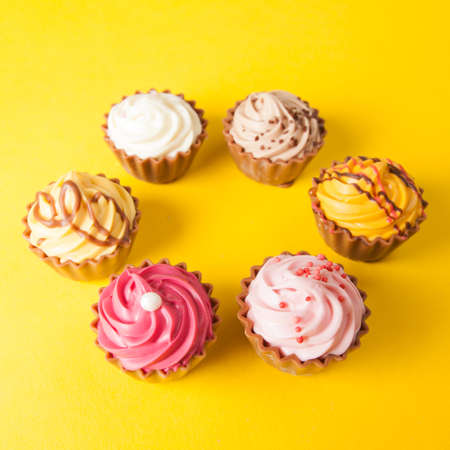 Chocolate cupcakes with yellow backgroudの写真素材