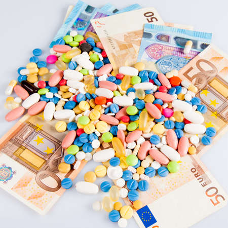 pills on money.  medicine tablets on moneyの写真素材