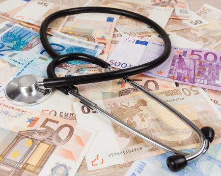 euro banknotes and stethoscope. Health care cost. medical concept