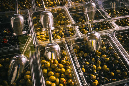 Olives at a market stall. Bowls of olives for sale at a marketの写真素材