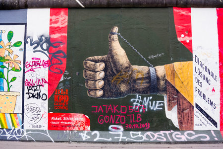 BERLIN, GERMANY - MARCH 20: Berlin Wall graffiti seen on March 22, 2015, Berlin, East Side Gallery. It's a 1.3 km long part of original Berlin Wall which collapsed in 1989のeditorial素材
