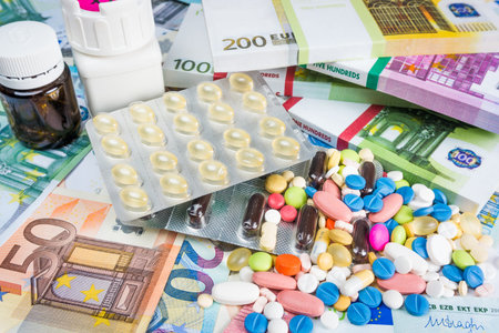 Money and pills. Pills of different colors on money. medicine concept. Euro cash
