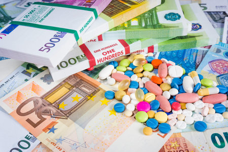 Money and pills. Pills of different colors on money. medicine concept. Euro cash
