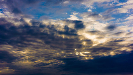 Beautiful cloudy sky with sun rays. Dramatic sky with stormy clouds