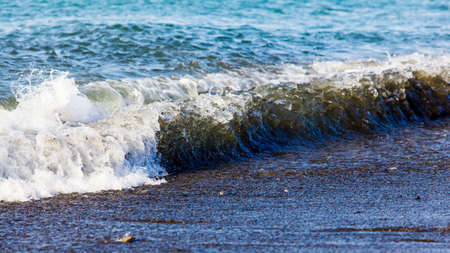 wave breaking along the beachの写真素材
