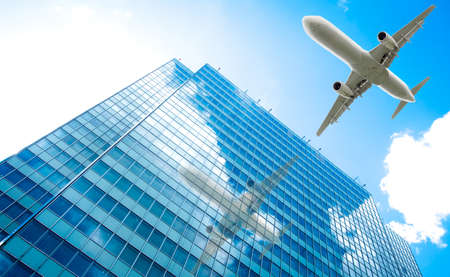 airplane with modern building. Jet over Cityの写真素材