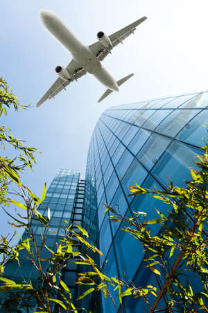 airplane with modern building. Jet over Cityの写真素材