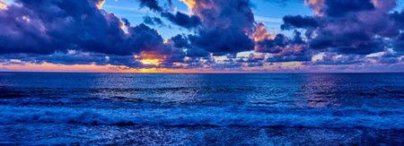 sunset over ocean. Sunset on the beach with beautiful sky. Dramatic sunsetの写真素材