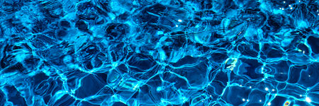 Water in swimming pool with sun reflection. Blue water. Water abstract background
