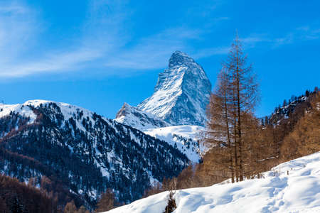 Scenic view on snowy Matterhorn peak in sunny day with blue sky.  Switzerlandの写真素材