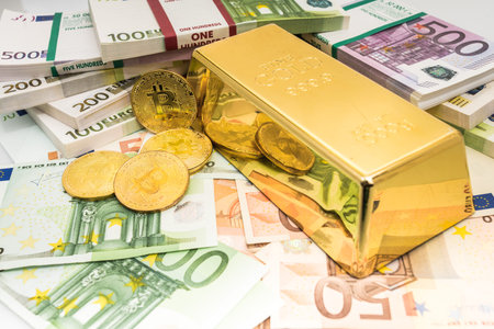 golden bitcoins with euro as a background with gold barの写真素材