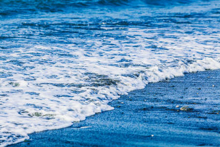 waves crashing on beachの写真素材
