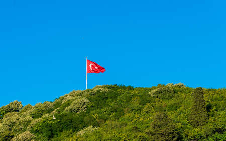 Turkish flag waving in blue skyの写真素材