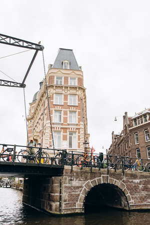 Amsterdam, Netherlands - September 5, 2017: Building of NH Doelen Hotel along canal.のeditorial素材